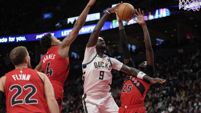 Toronto Raptors forward Scottie Barnes (4) and forward Chris Boucher (25) block a shot by Milwaukee Bucks forward Bobby Portis (9)